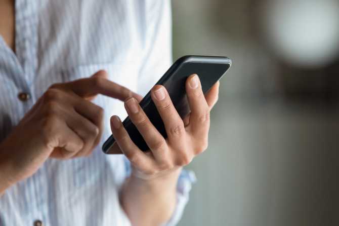Person dialing on a phone
